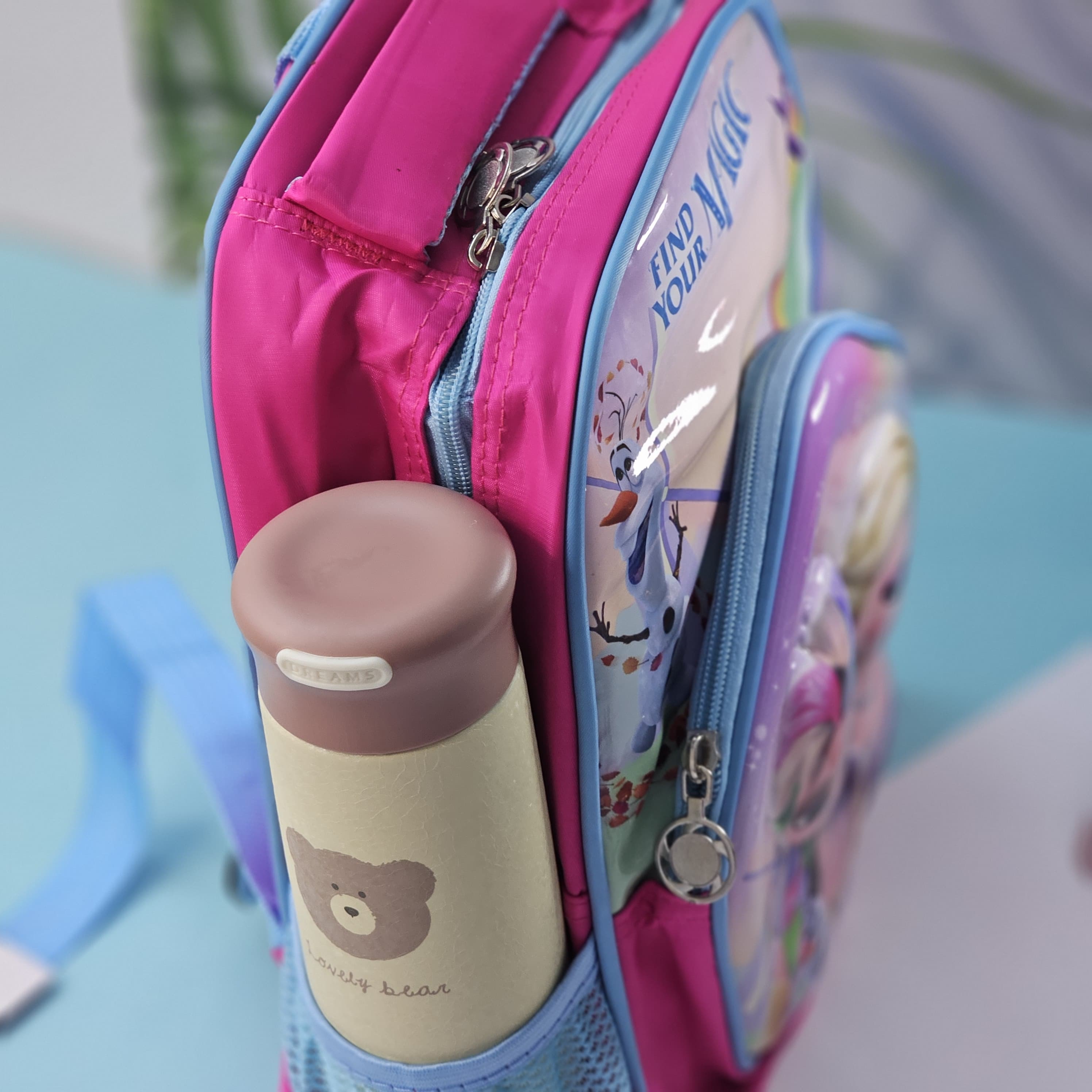 U Smile Toys vibrant Frozen-themed school bag for girls, with a prominent 'Find Your Magic' slogan and beloved characters